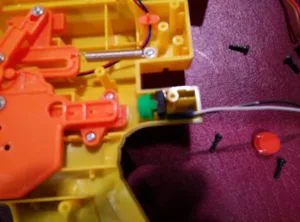 Digital switch wired in to replace the Nerf gun's mechanical trigger for Arduino input