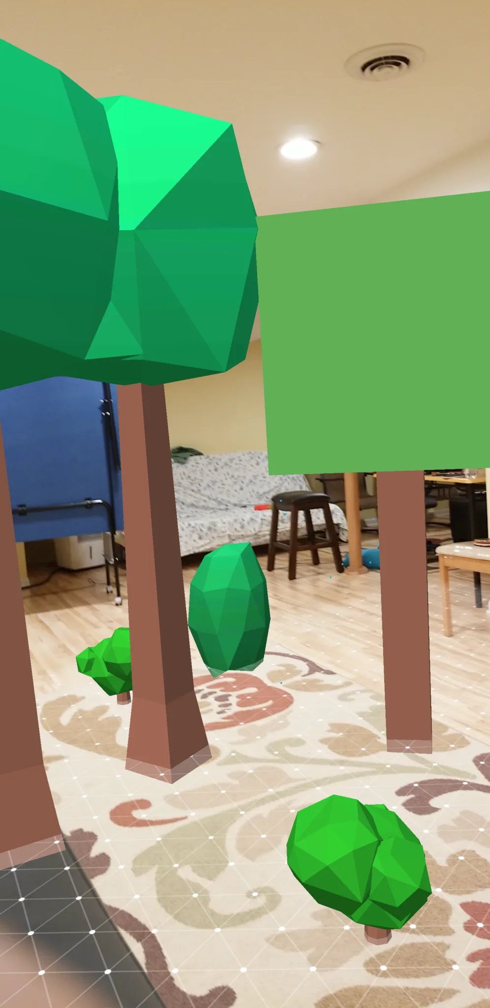 Cluster of AR-placed trees and rocks in a real room using ARCore